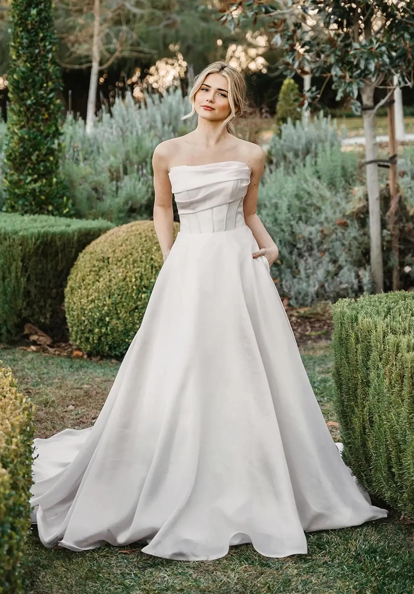 Model wearing a white gown by Stella York